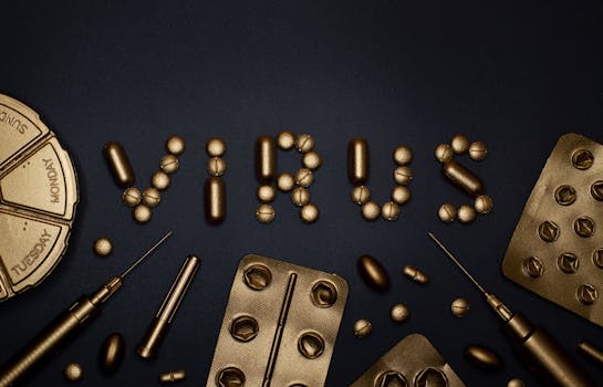Conceptual image featuring gold pills and syringes forming the word 'virus' on a dark backdrop.