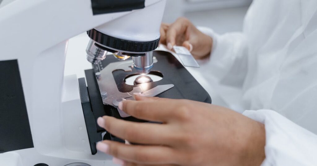 Scientist in laboratory using a microscope for detailed sample analysis.